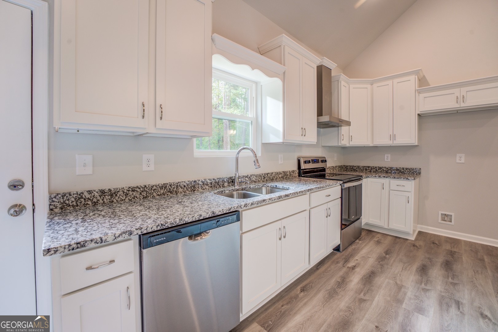359 Whippoorwill Road Monticello, GA 31064 - Photo 13 of 37 a kitchen with granite countertop white cabinets and white appliances