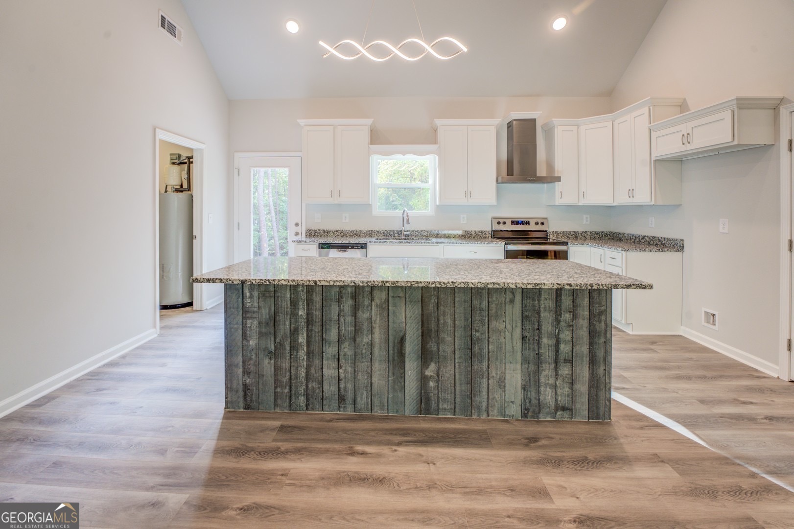 359 Whippoorwill Road Monticello, GA 31064 - Photo 15 of 37 a kitchen with kitchen island granite countertop a stove a sink a refrigerator and a microwave