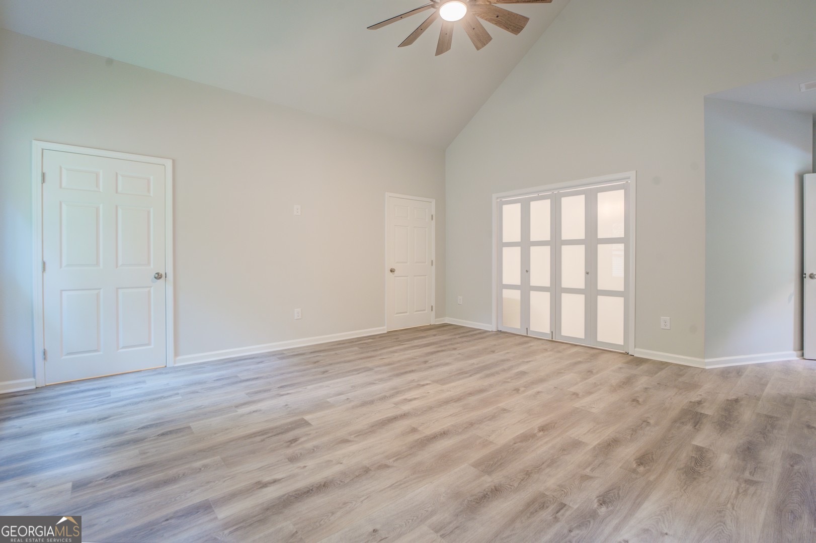359 Whippoorwill Road Monticello, GA 31064 - Photo 18 of 37 a view of an empty room with a window and wooden floor