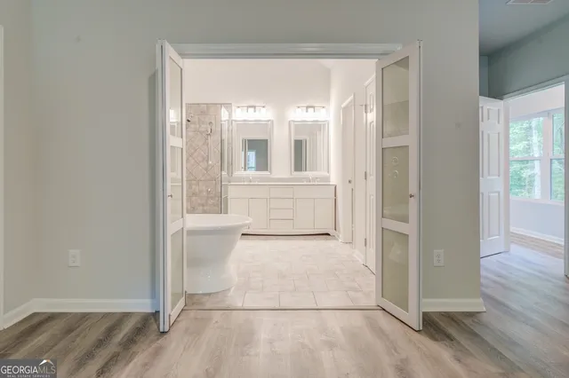 an empty room with wooden floor and a window