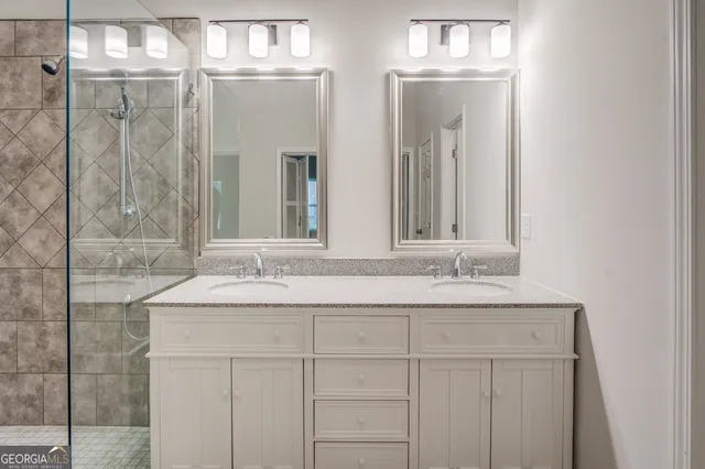 a bathroom with double sink and a mirror