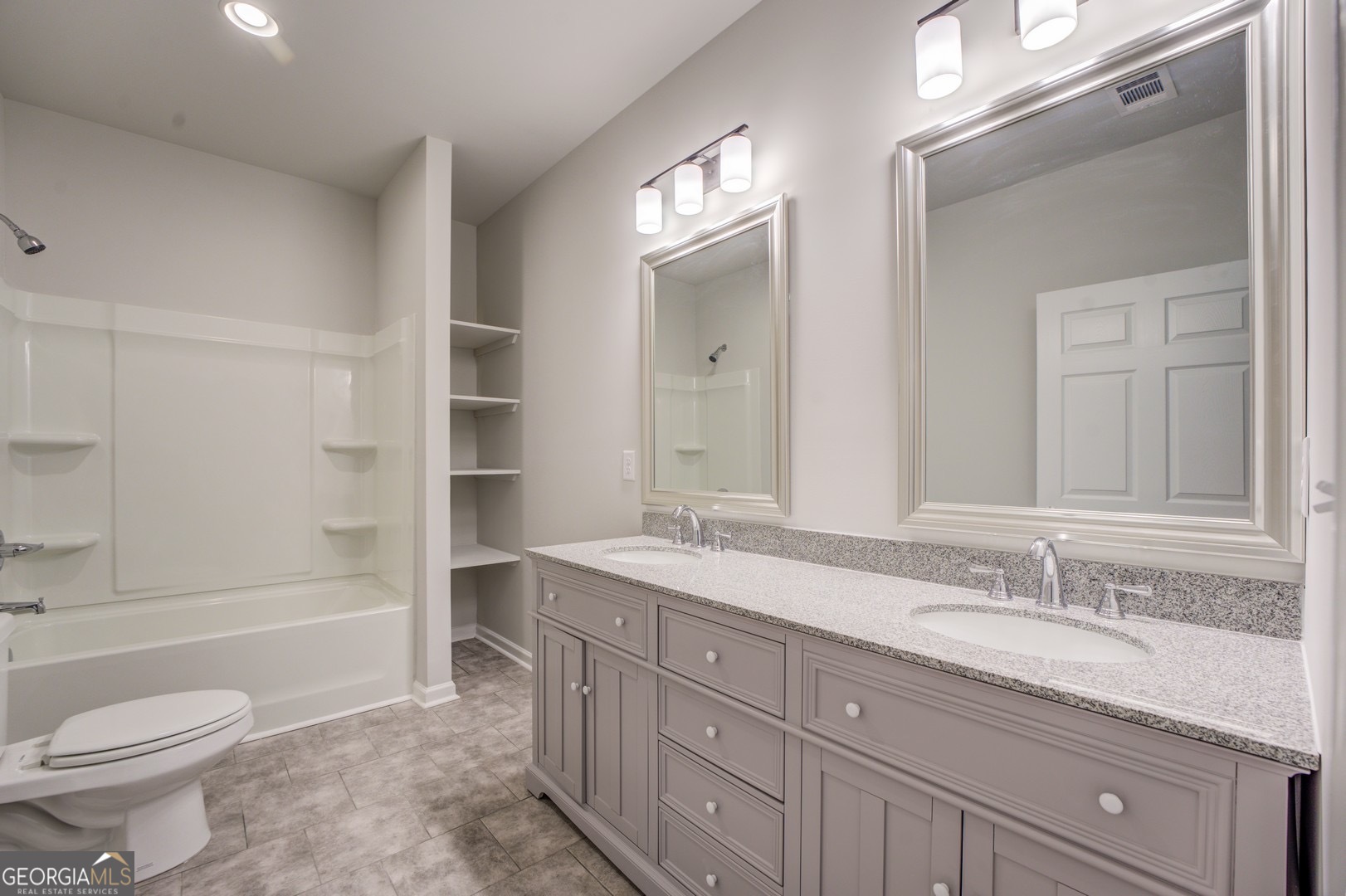 359 Whippoorwill Road Monticello, GA 31064 - Photo 32 of 37 a spacious bathroom with a granite countertop sink toilet mirror and bathtub