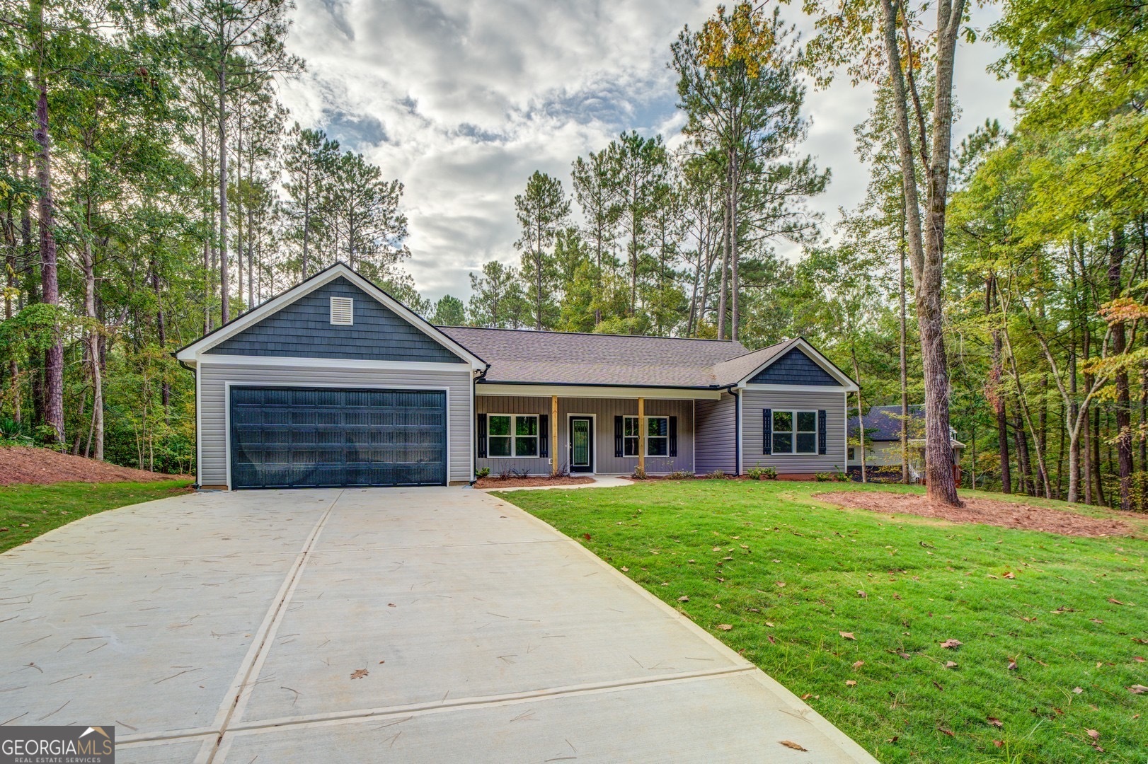 359 Whippoorwill Road Monticello, GA 31064 - Photo 5 of 37 a front view of a house with a yard and trees