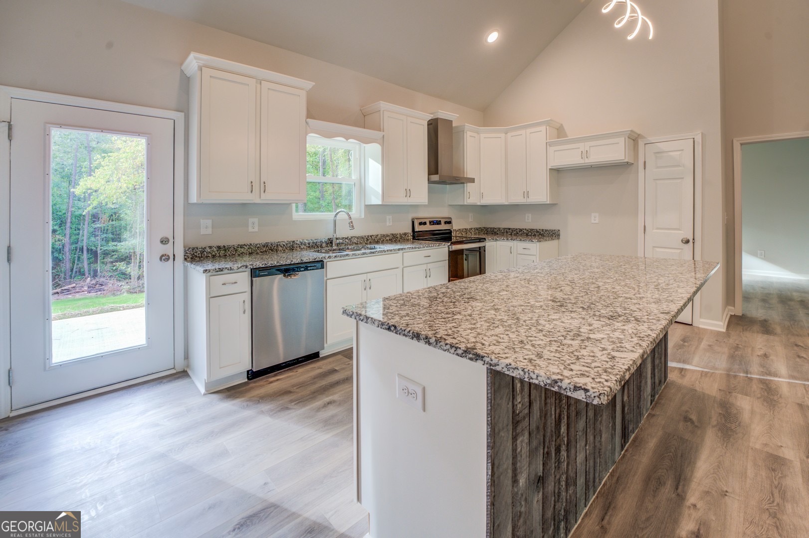 359 Whippoorwill Road Monticello, GA 31064 - Photo 6 of 37 a kitchen with granite countertop kitchen island a sink stove and cabinets