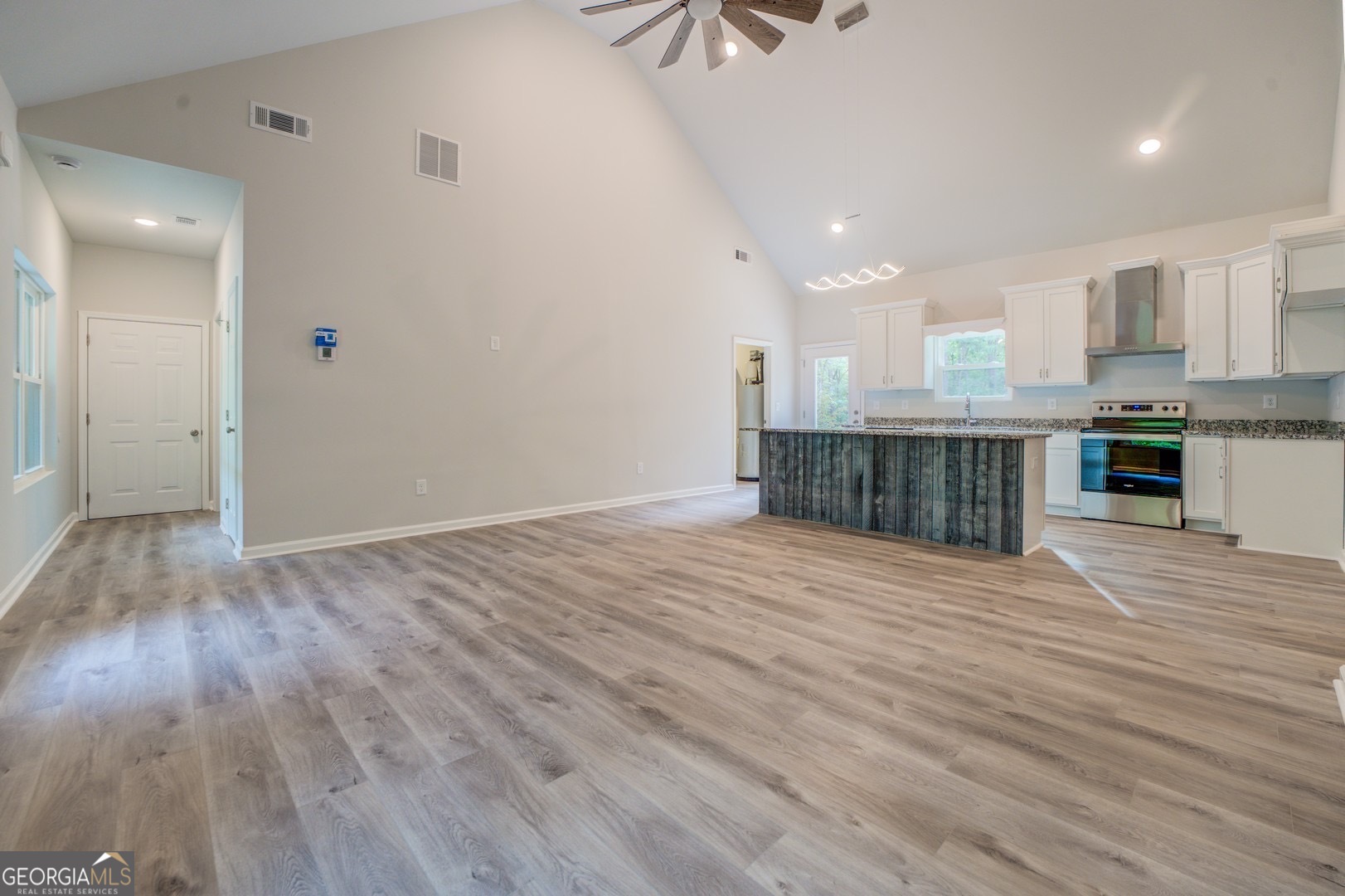 359 Whippoorwill Road Monticello, GA 31064 - Photo 8 of 37 a view of a kitchen with wooden floor and electronic appliances