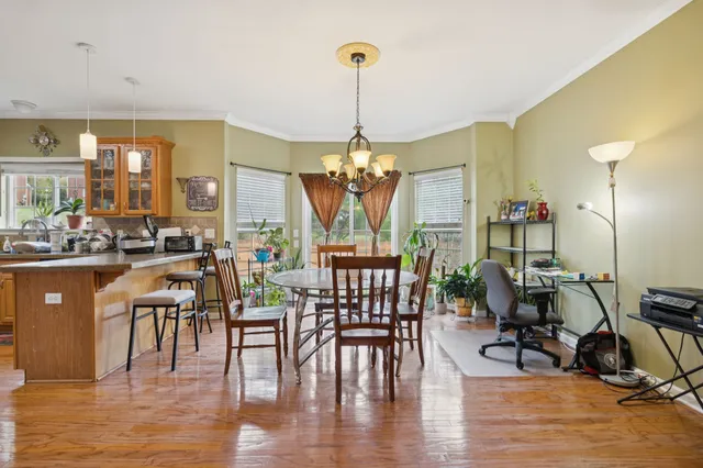 a view of a dining room with furniture window and wooden floor