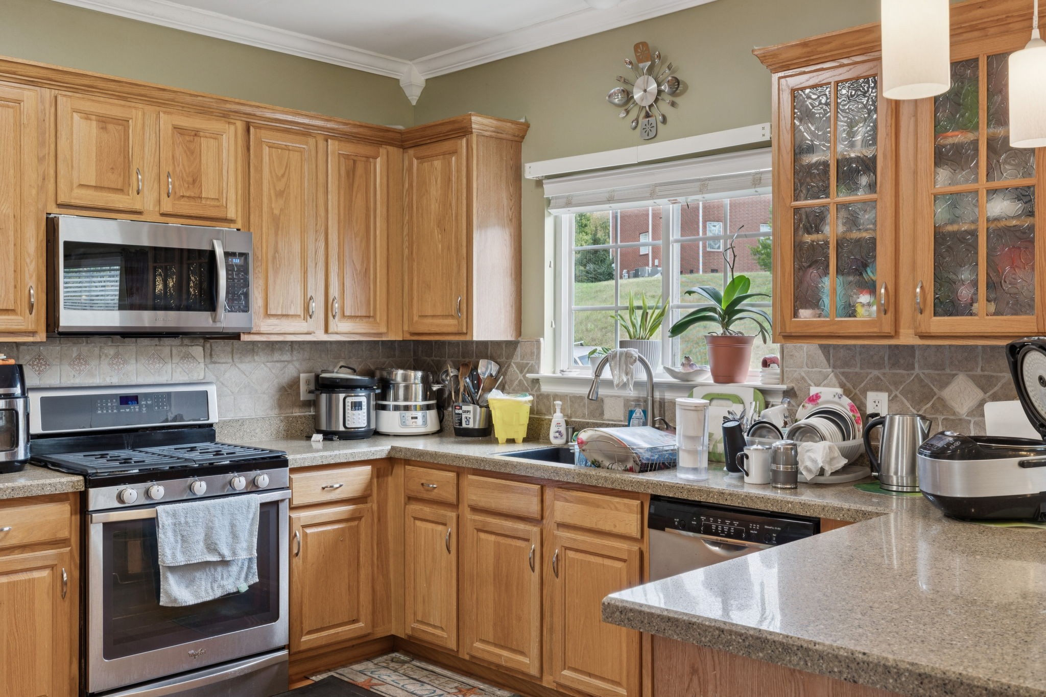 1728 Liberty Pike Franklin, TN 37067 - Photo 15 of 52 a kitchen with stainless steel appliances granite countertop a sink a stove and a microwave