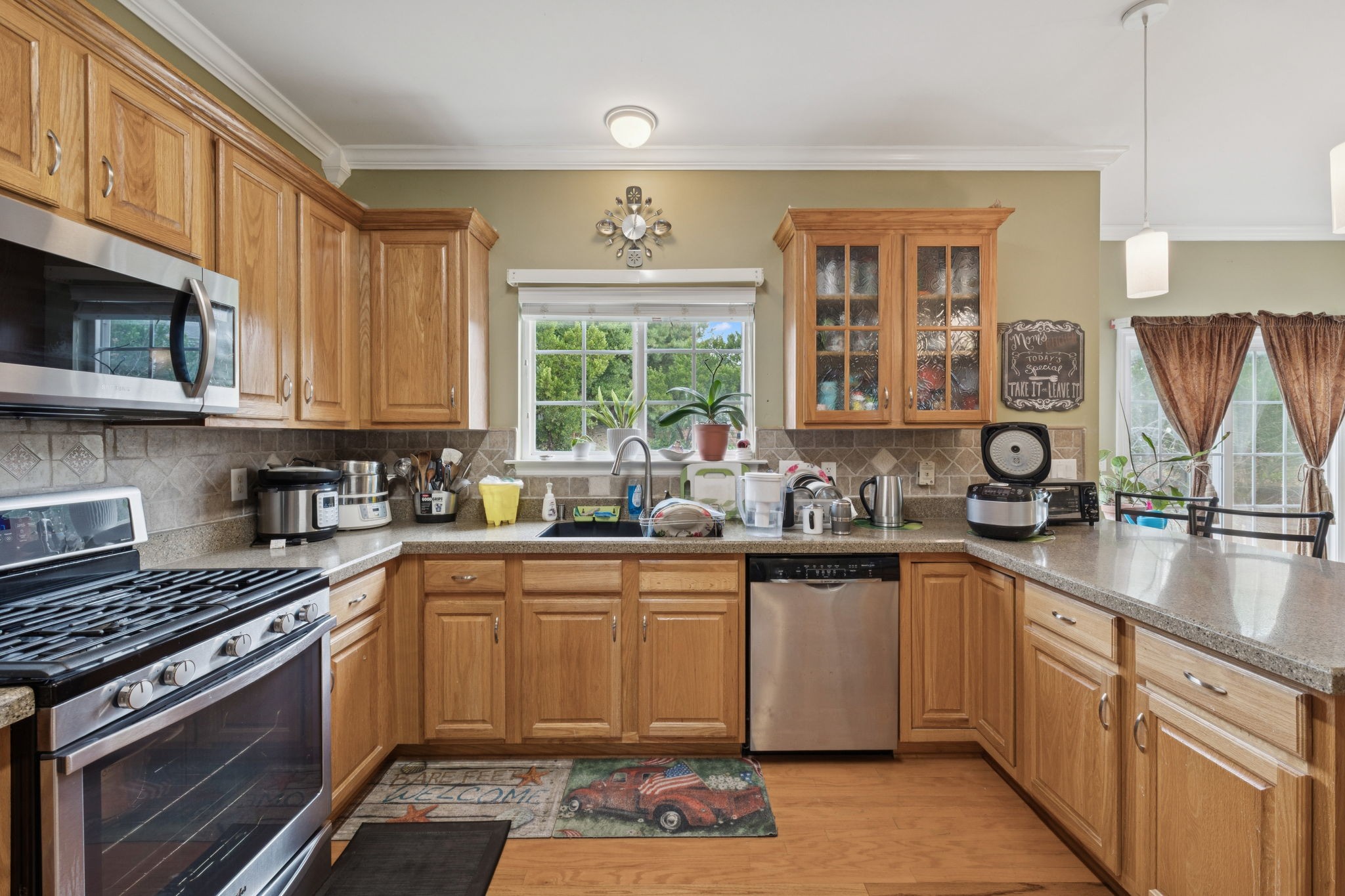 1728 Liberty Pike Franklin, TN 37067 - Photo 23 of 52 a kitchen with stainless steel appliances granite countertop a stove sink and cabinets
