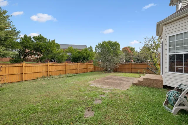 a view of a house with a yard and garage