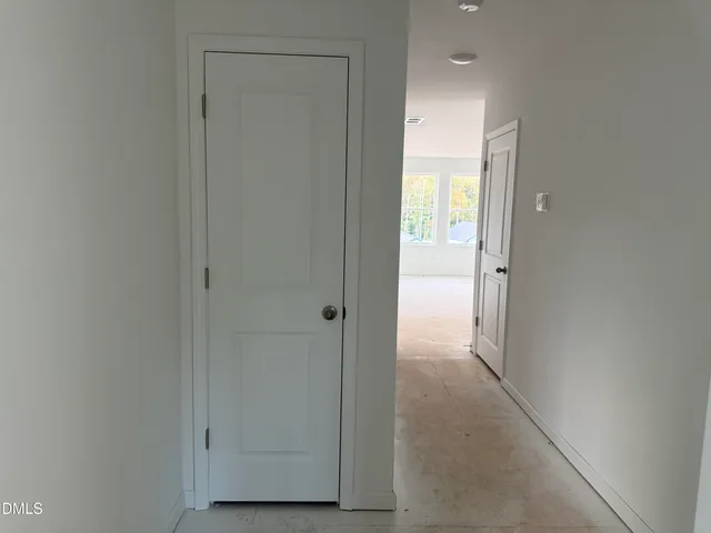 a view of a hallway with wooden floor and entryway