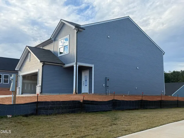 an empty room with wooden floor and a door