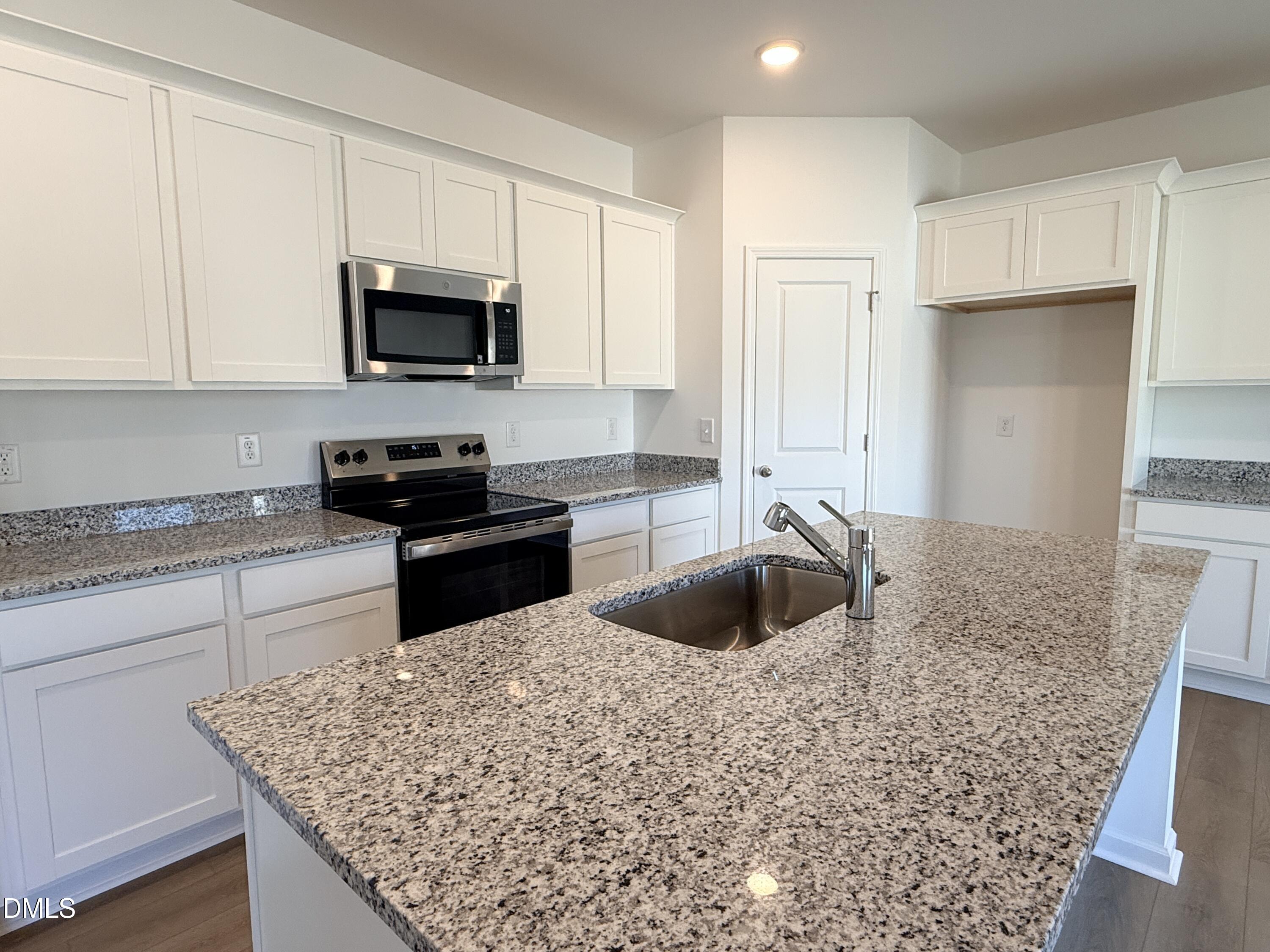 11790 Salers Loop Middlesex, NC 27557 - Photo 35 of 43 a kitchen with stainless steel appliances granite countertop a sink stove and refrigerator