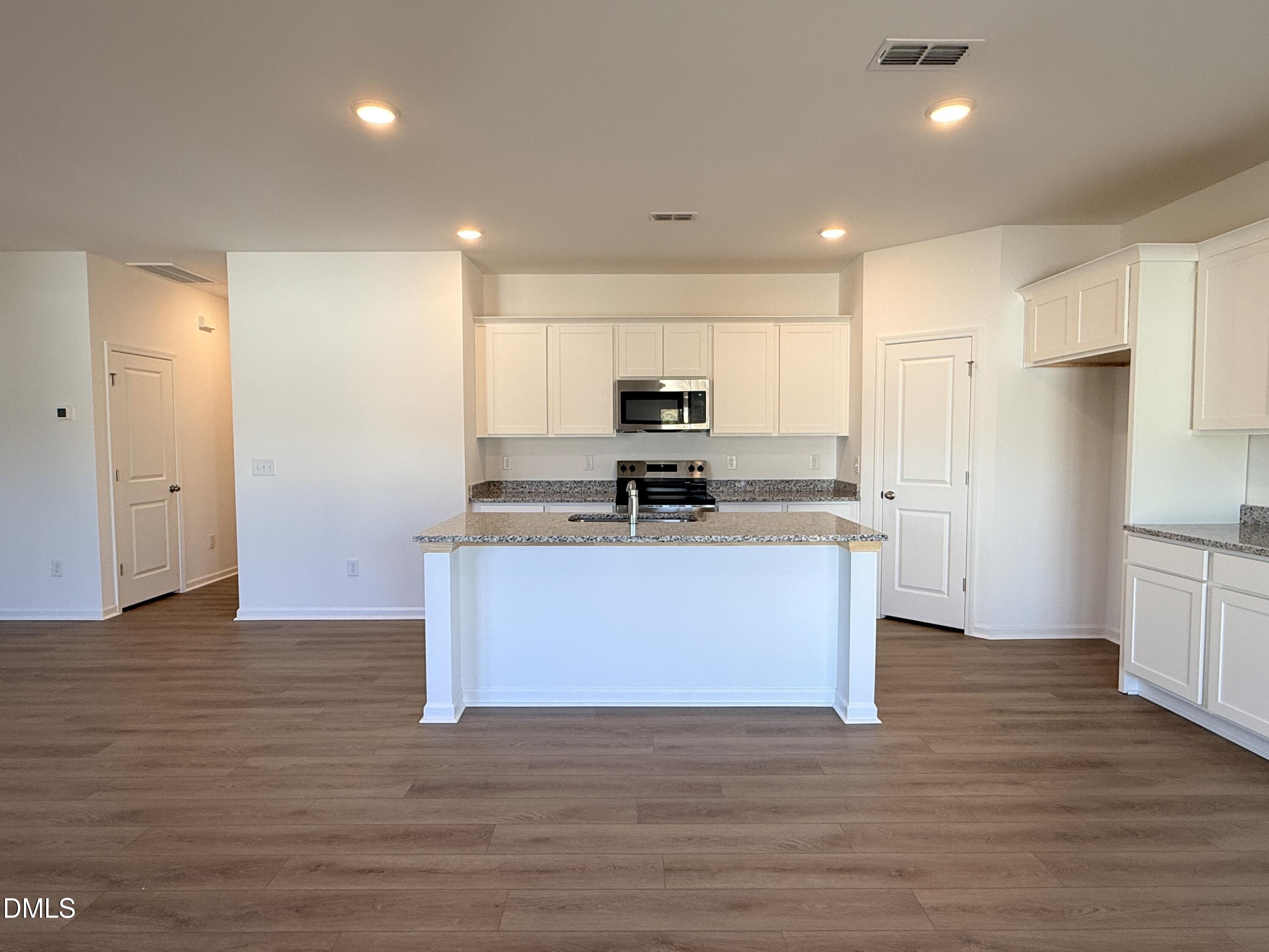 11790 Salers Loop Middlesex, NC 27557 - Photo 38 of 43 a large kitchen with stainless steel appliances granite countertop a stove a sink and a refrigerator