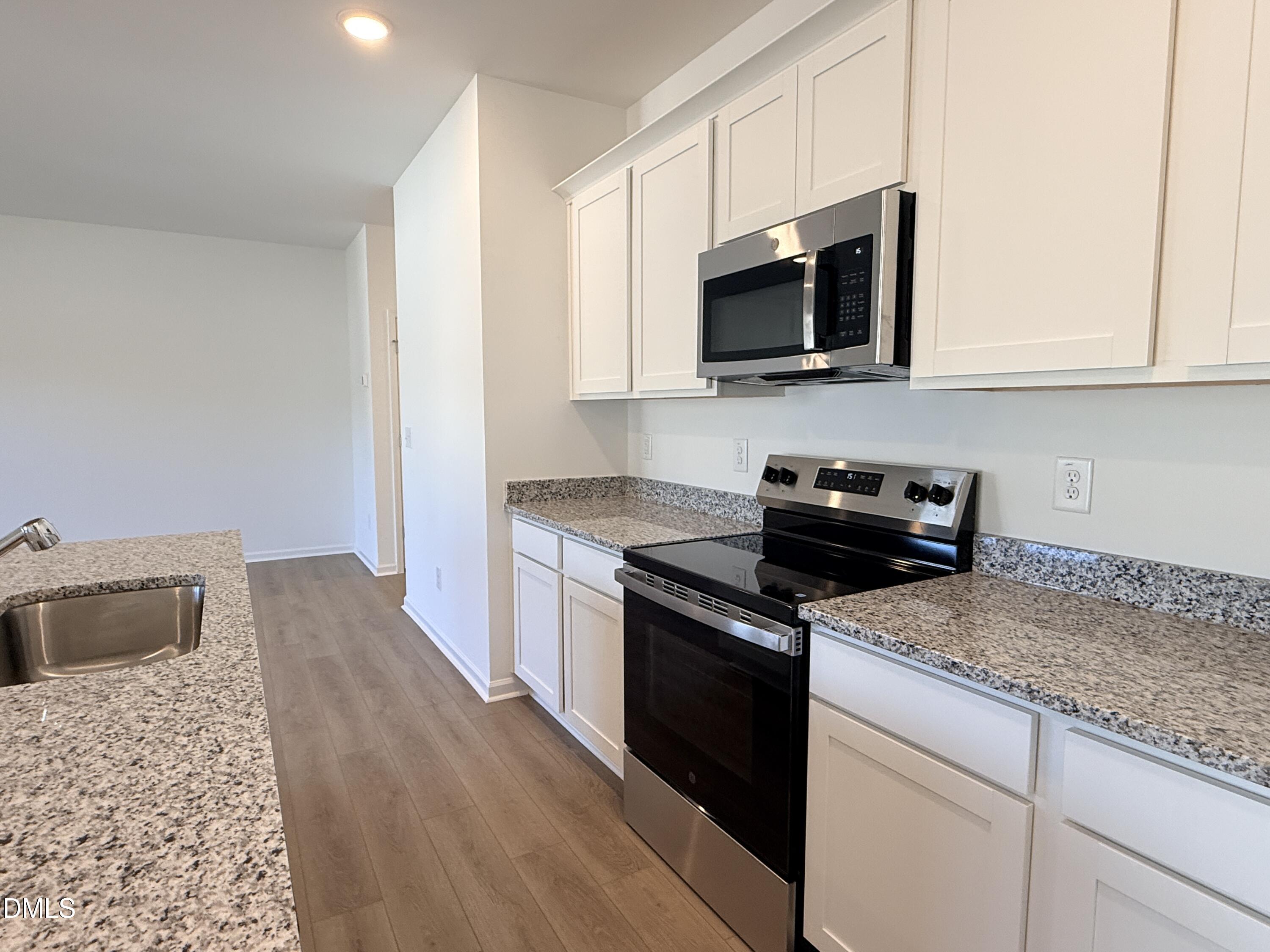 11790 Salers Loop Middlesex, NC 27557 - Photo 41 of 43 a kitchen with granite countertop a sink dishwasher stove and microwave with wooden floor