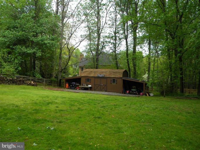 11317 Vale Road Oakton, VA 22124 - Photo 13 of 29 a view of a house with backyard sitting area and garden