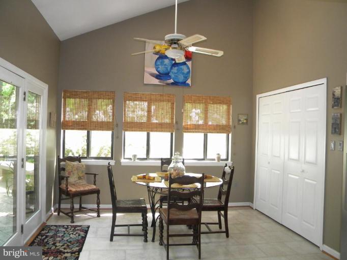 11317 Vale Road Oakton, VA 22124 - Photo 14 of 29 a dining room with wooden floor and a chandelier