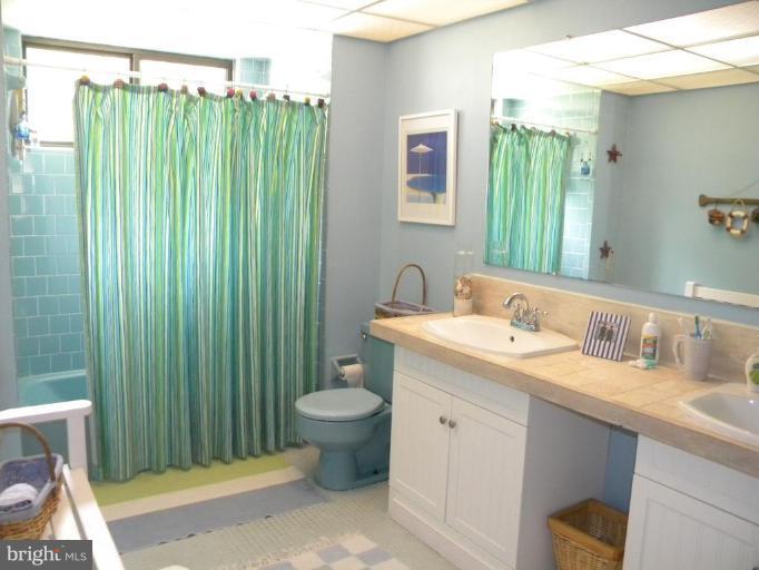11317 Vale Road Oakton, VA 22124 - Photo 16 of 29 a bathroom with a granite countertop sink toilet and shower