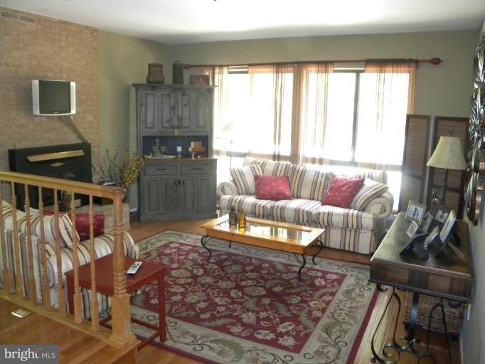 11317 Vale Road Oakton, VA 22124 - Photo 21 of 29 a living room with furniture and a flat screen tv