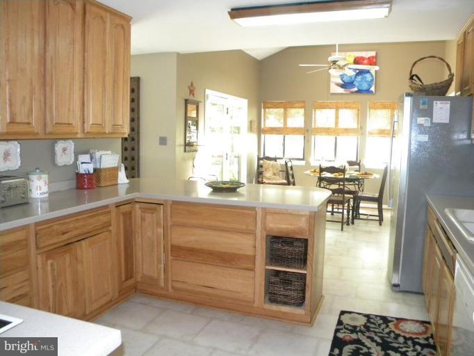 11317 Vale Road Oakton, VA 22124 - Photo 24 of 29 a kitchen with stainless steel appliances kitchen island granite countertop a refrigerator and cabinets