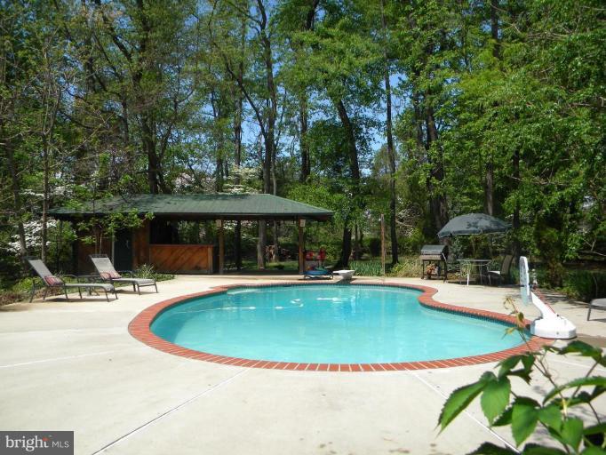 11317 Vale Road Oakton, VA 22124 - Photo 6 of 29 a view of a swimming pool with a patio