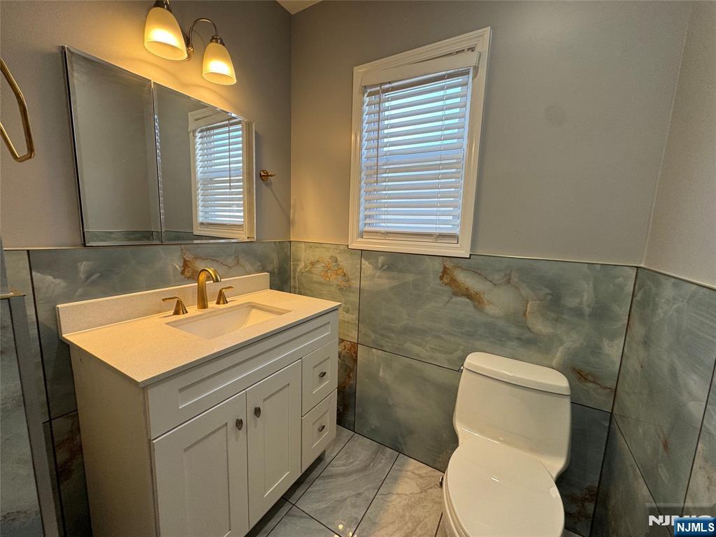 243 Hamilton Place, Unit 2 Hackensack, NJ 07601 - Photo 7 of 9 a bathroom with a sink toilet and mirror