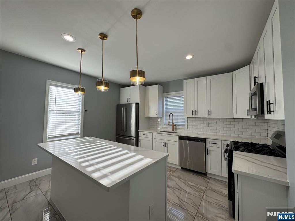 243 Hamilton Place, Unit 2 Hackensack, NJ 07601 - Photo 9 of 9 a kitchen with stainless steel appliances granite countertop a sink a stove and a refrigerator