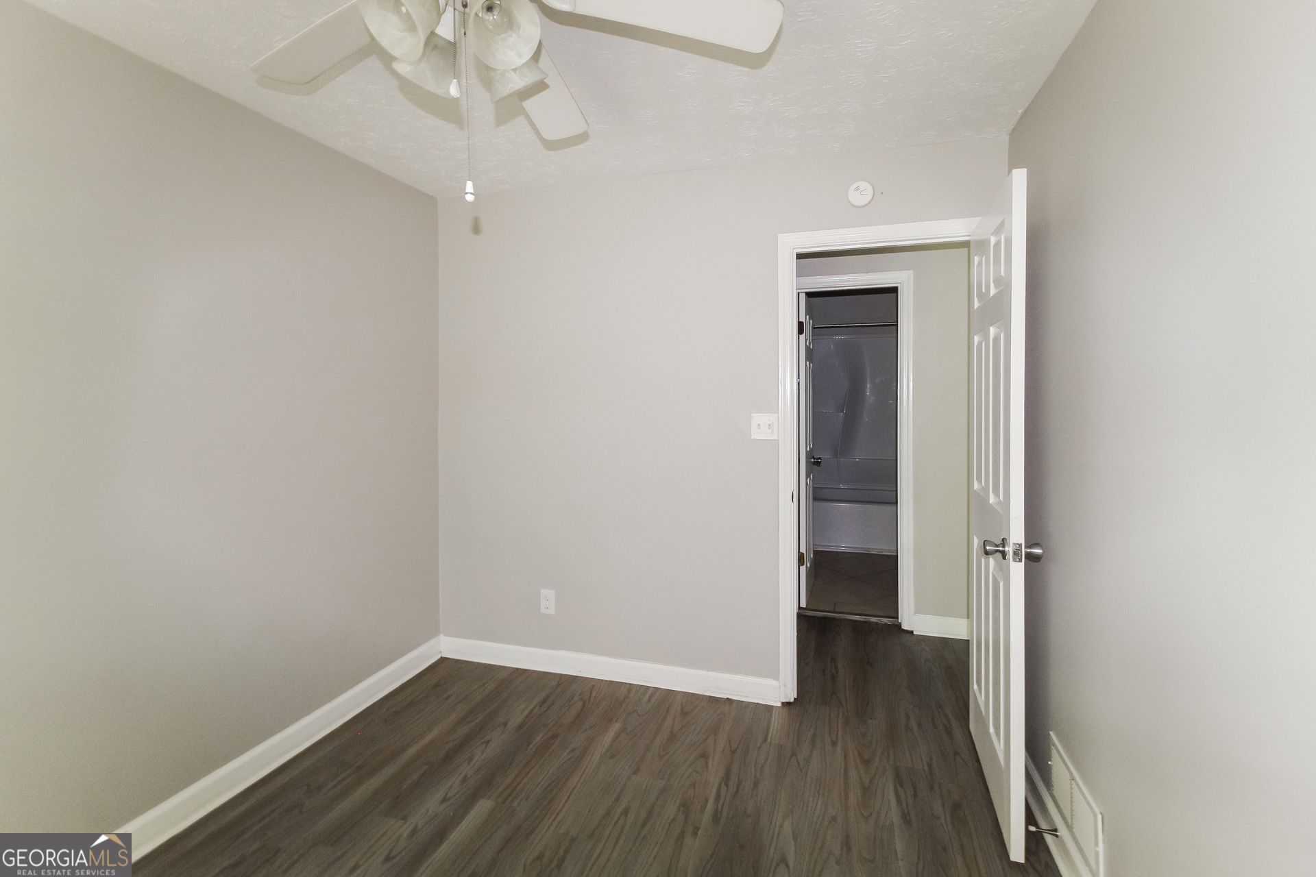 858 Martin Road Stone Mountain, GA 30088 - Photo 13 of 15 wooden floor in an empty room with a window