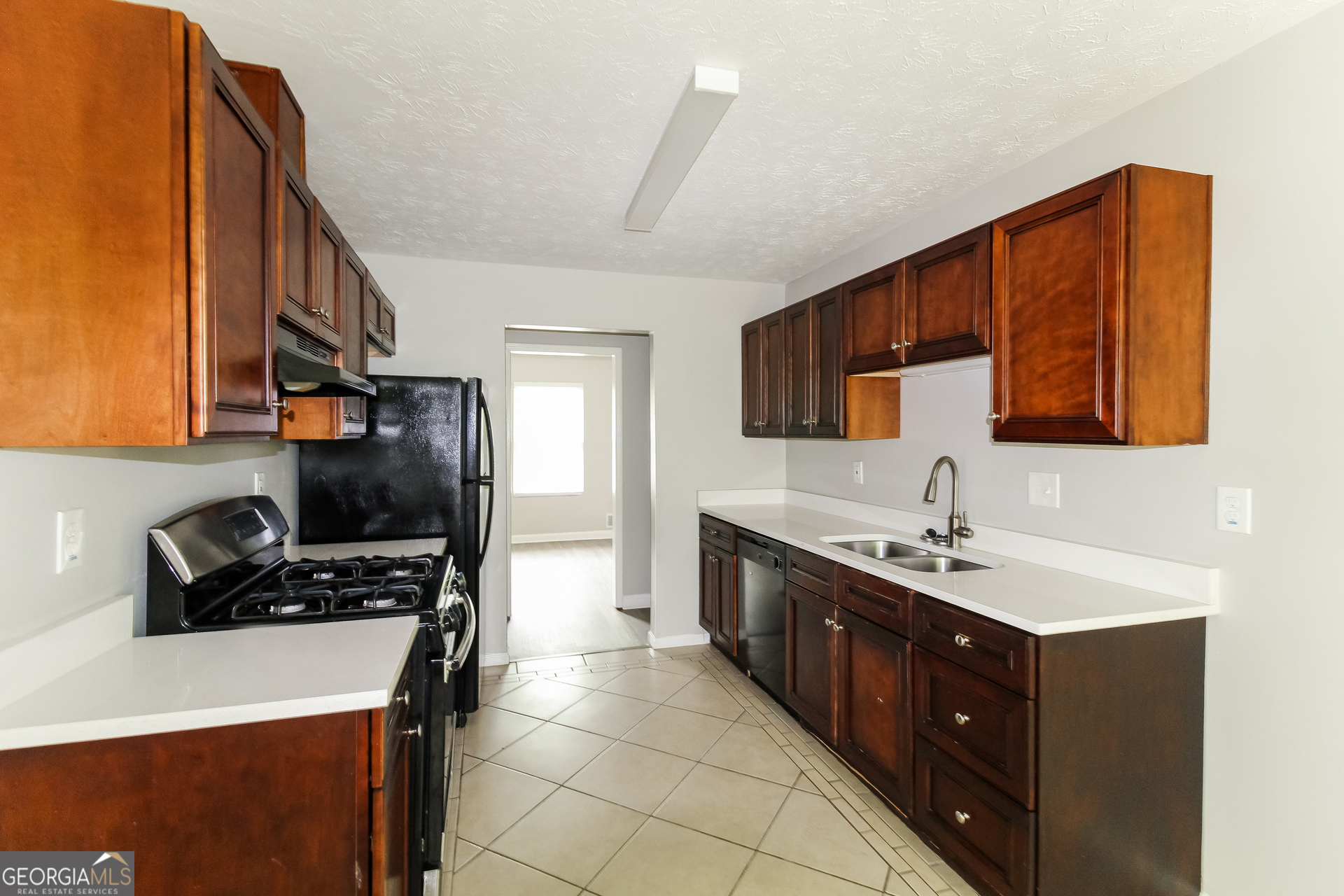 858 Martin Road Stone Mountain, GA 30088 - Photo 5 of 15 a kitchen with a sink appliances and cabinets