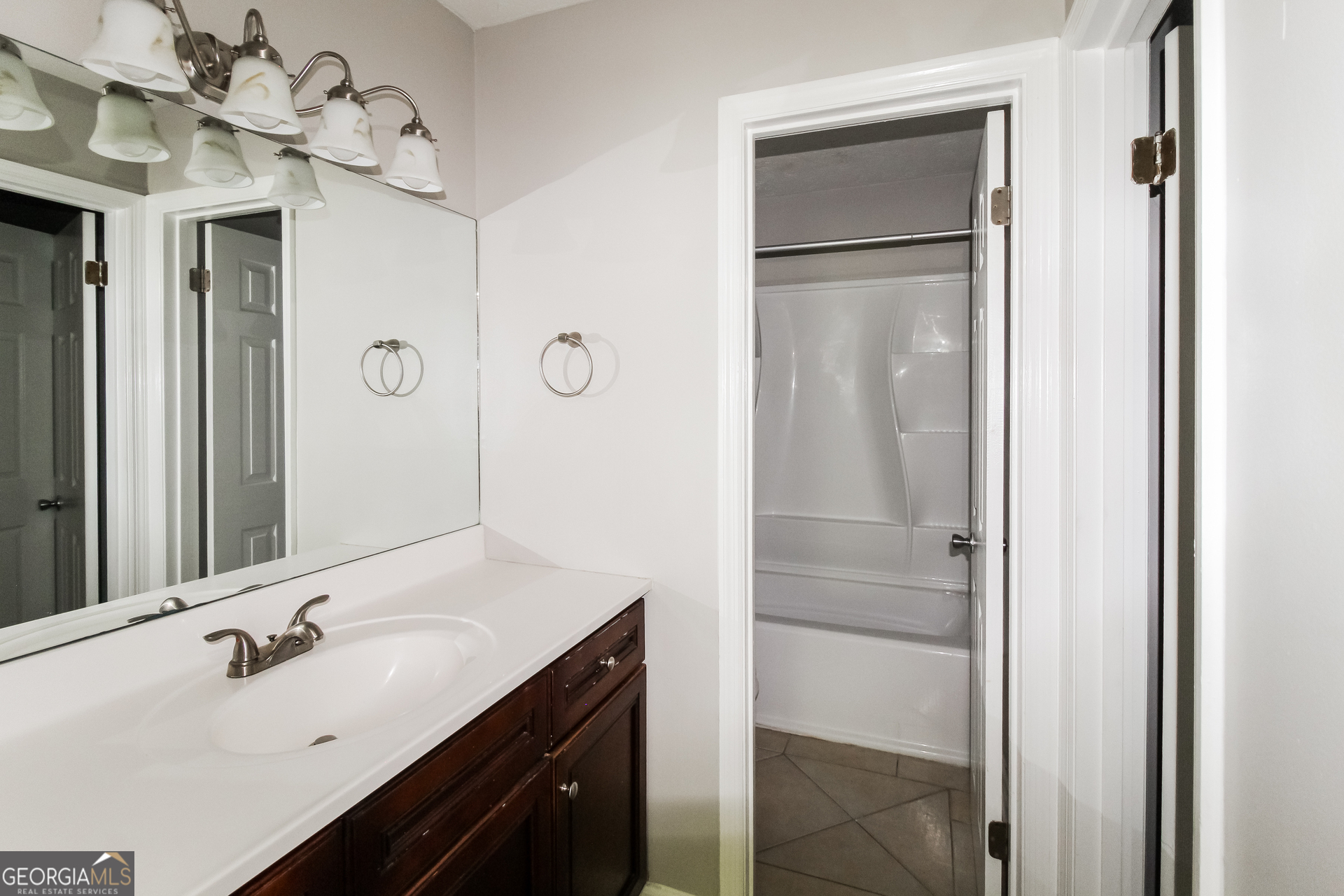 858 Martin Road Stone Mountain, GA 30088 - Photo 9 of 15 a bathroom with a double vanity sink mirror and shower