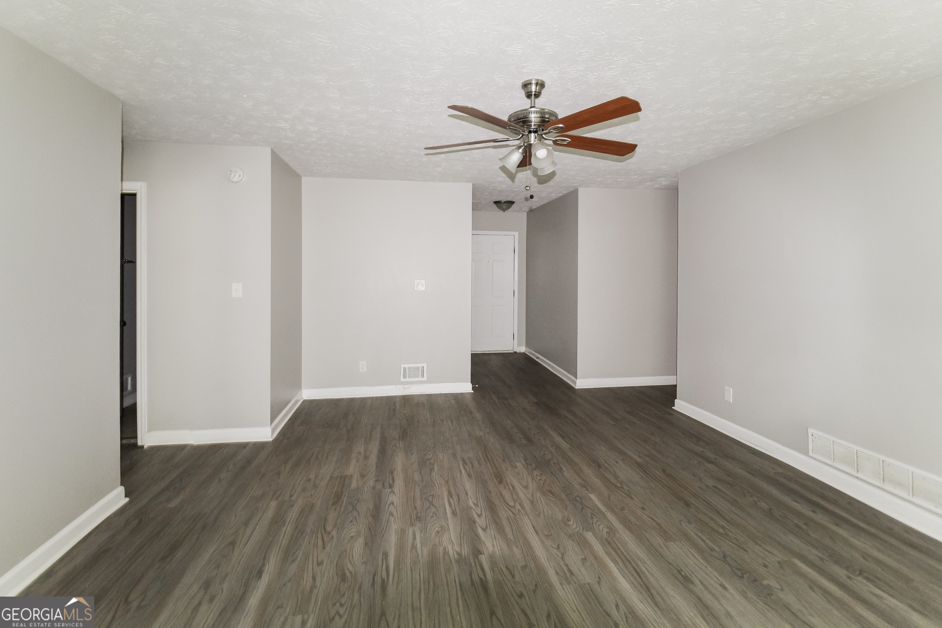 858 Martin Road Stone Mountain, GA 30088 - Photo 10 of 15 a view of a room with wooden floor and ceiling fan