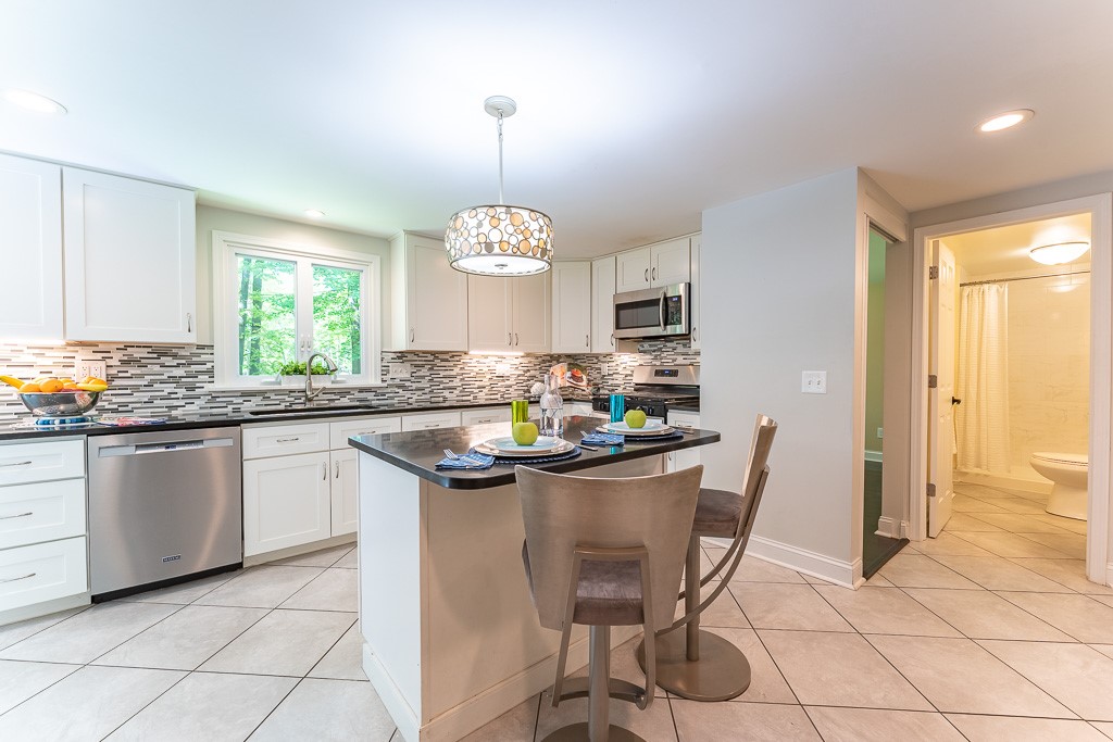 220 Hibiscus Drive Rochester, NY 14618 - Photo 11 of 50 Thoughtfully updated, it blends style and function with solid surface counters, stainless steel appliances and a glass and ceramic backsplash.