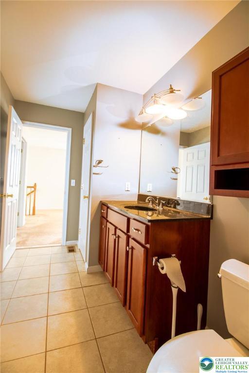 4129 Coleman Street Bethlehem, PA 18020 - Photo 28 of 36 a bathroom with a sink a toilet a mirror and vanity