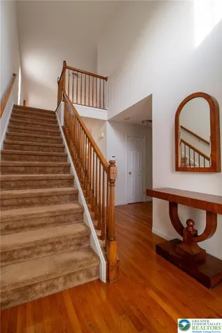 a view of entryway and hall with wooden floor