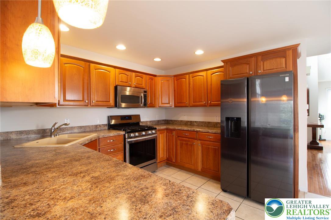 4129 Coleman Street Bethlehem, PA 18020 - Photo 9 of 36 a kitchen with stainless steel appliances granite countertop a refrigerator a sink a stove and dishwasher