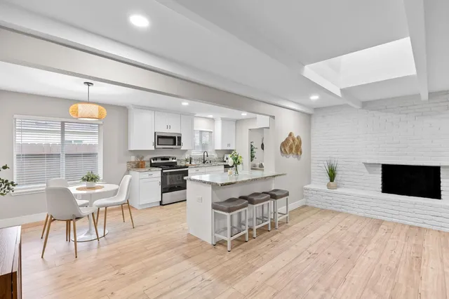 a living room with furniture wooden floor and a fireplace