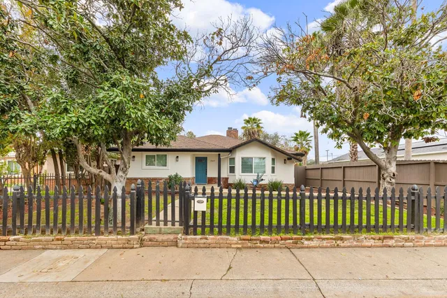 a front view of a house with a garden
