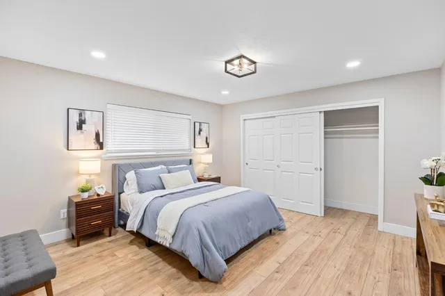 a bedroom with a bed and a window