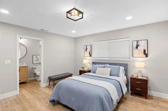 a bedroom with a bed and a table