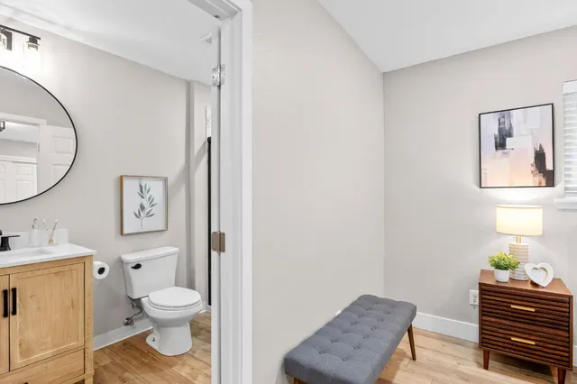 a bathroom with a toilet a sink and a mirror