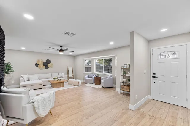 a living room with furniture window and wooden floor