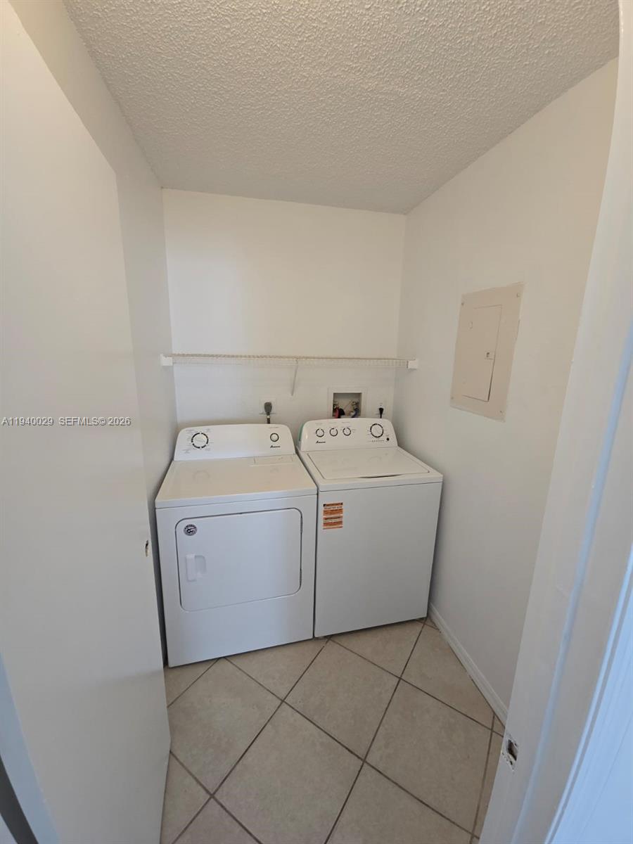 4035 West McNab Road, Unit F210 Pompano Beach, FL 33069 - Photo 13 of 22 a utility room with dryer and washer