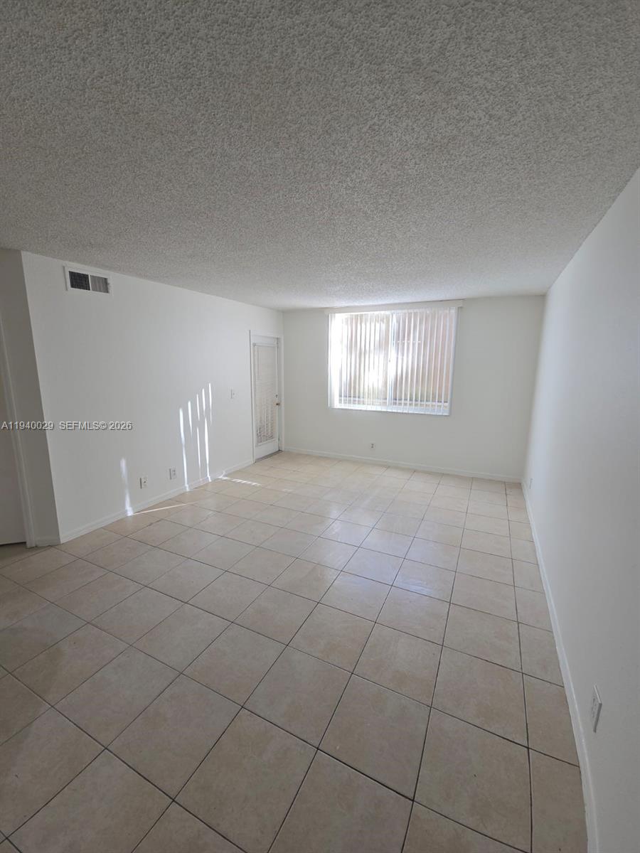 4035 West McNab Road, Unit F210 Pompano Beach, FL 33069 - Photo 14 of 22 a view of an empty room and window