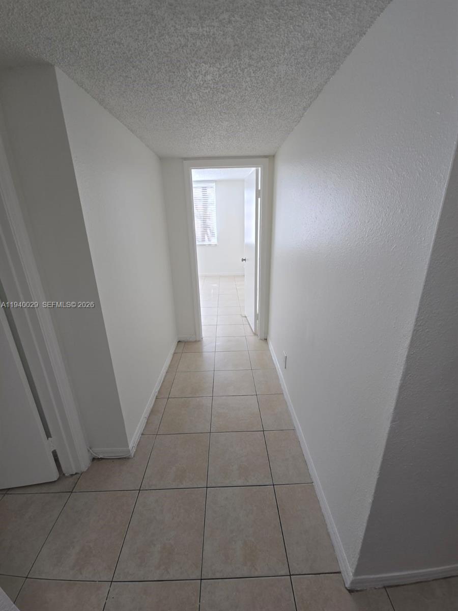 4035 West McNab Road, Unit F210 Pompano Beach, FL 33069 - Photo 18 of 22 a view of an empty room and a window
