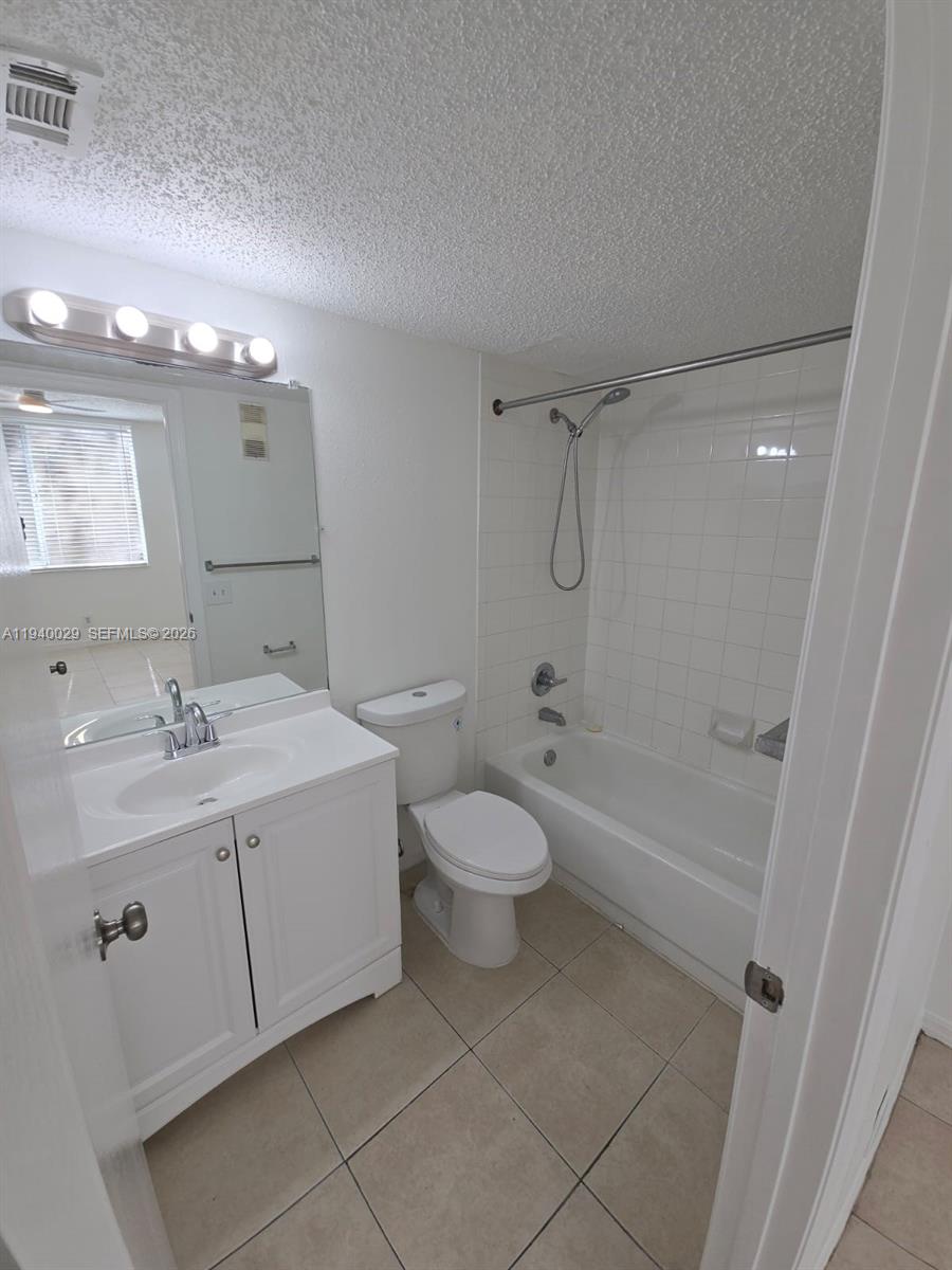 4035 West McNab Road, Unit F210 Pompano Beach, FL 33069 - Photo 19 of 22 a bathroom with a sink toilet and shower