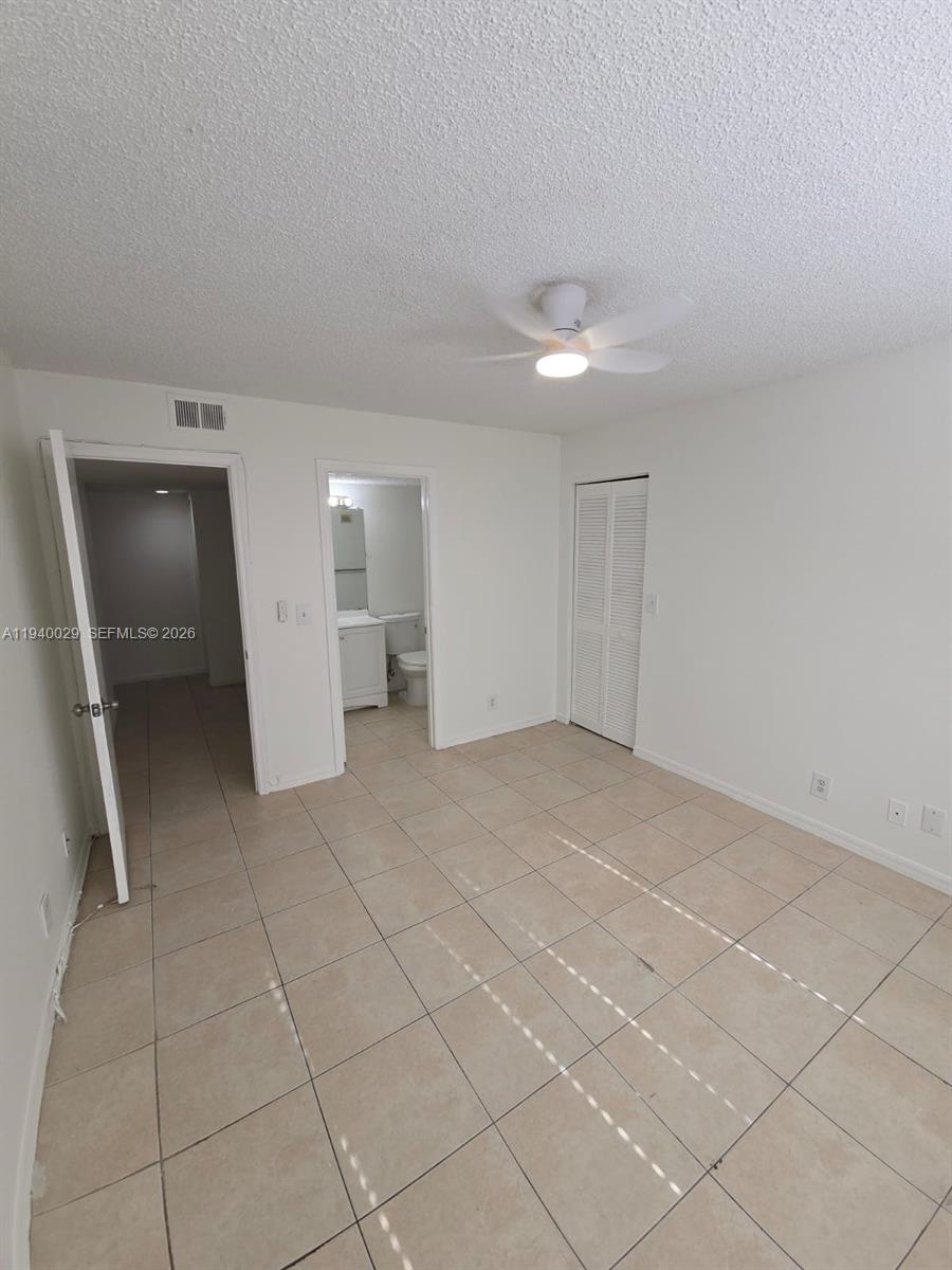 4035 West McNab Road, Unit F210 Pompano Beach, FL 33069 - Photo 20 of 22 a view of an empty room with a bathroom