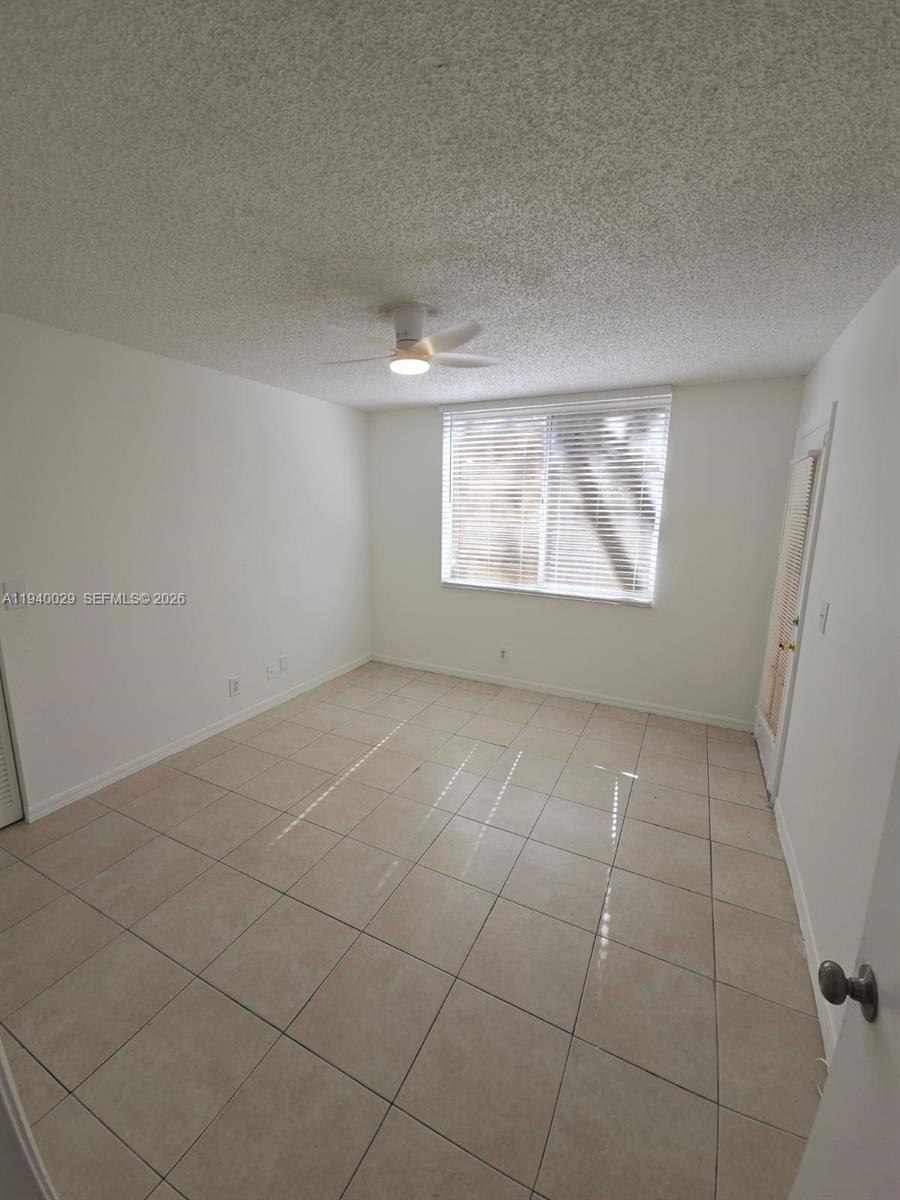 4035 West McNab Road, Unit F210 Pompano Beach, FL 33069 - Photo 2 of 22 an empty room with windows and entrance