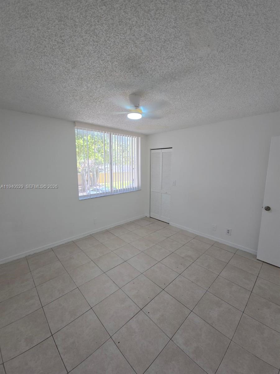 4035 West McNab Road, Unit F210 Pompano Beach, FL 33069 - Photo 22 of 22 an empty room with windows