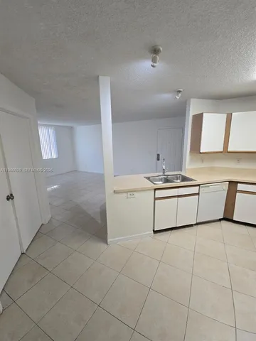 a room with a sink a washer and dryer
