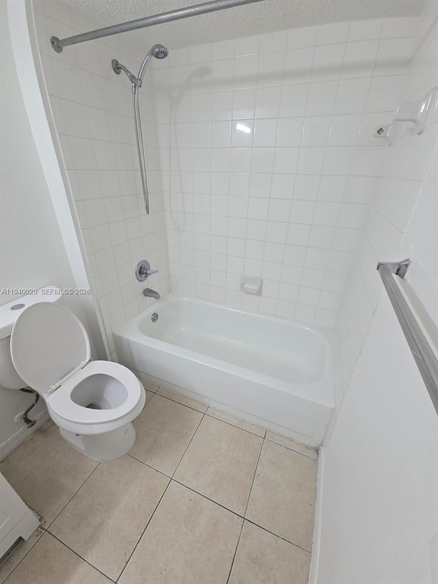 4035 West McNab Road, Unit F210 Pompano Beach, FL 33069 - Photo 8 of 22 a bathroom with a toilet and a shower