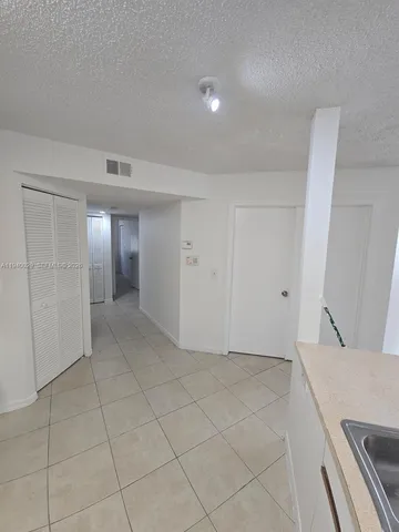a kitchen with a refrigerator a stove a sink and a cabinets